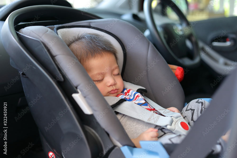 cute baby boy sleeping in car seat safety belt lock protection drive road trip travel