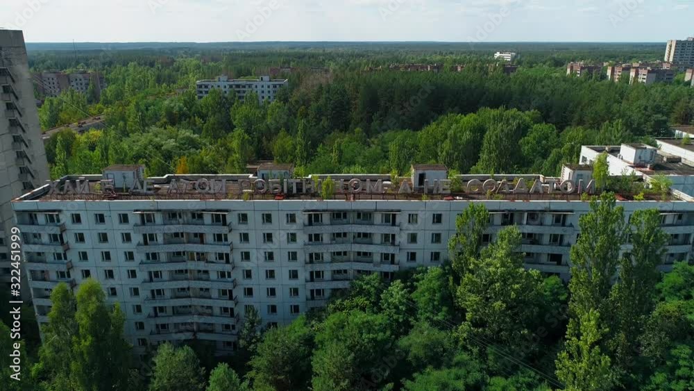 Aerial view of abandoned buildings and streets in city Pripyat near Chernobyl nuclear power plant. Cyrillic inscription Aerial view of abandoned buildings and streets in city Pripyat near Chernobyl nuclear power plant. Cyrillic inscription