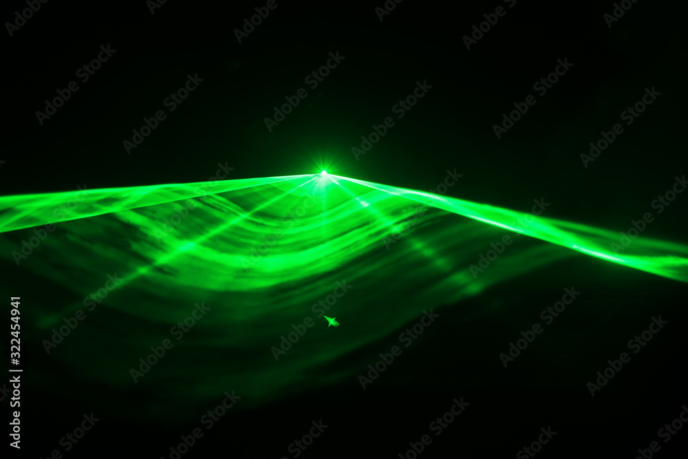 Green laser in black background - obrazy, fototapety, plakaty 