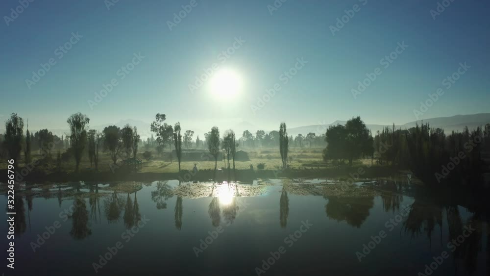 Aerial dolly in revealing the volcanoes in Xochimilco at sunrise Aerial dolly in revealing the volcanoes in Xochimilco at sunrise