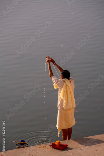 robed man doing puja at Pushkar