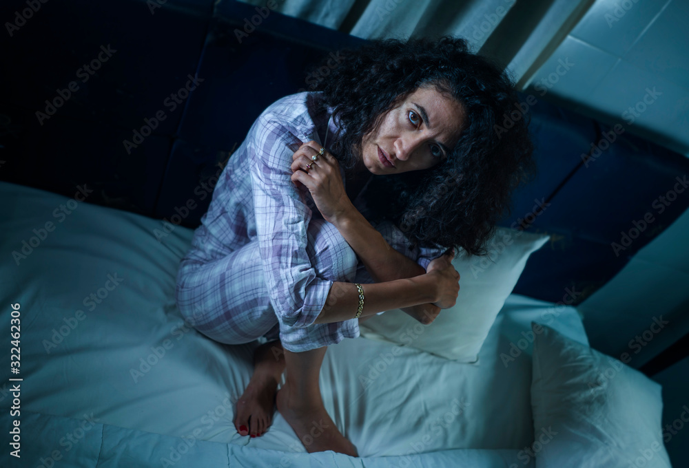 dramatic night lifestyle portrait of young sad and depressed latin woman with curly hair sleepless in bed awake and thoughtful feeling worried suffering depression dramatic night lifestyle portrait of young sad and depressed latin woman with curly hair sleepless in bed awake and thoughtful feeling worried suffering depression