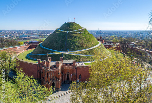 Fototapeta Naklejka Na Ścianę i Meble -  Kosciuszko Mound (Kopiec Kościuszki). Krakow landmark, Poland. Erected in 1823 to commemorate Tadedeusz Kosciuszko, and the chapel of St. Bronislawa. Aerial view in sunrise light