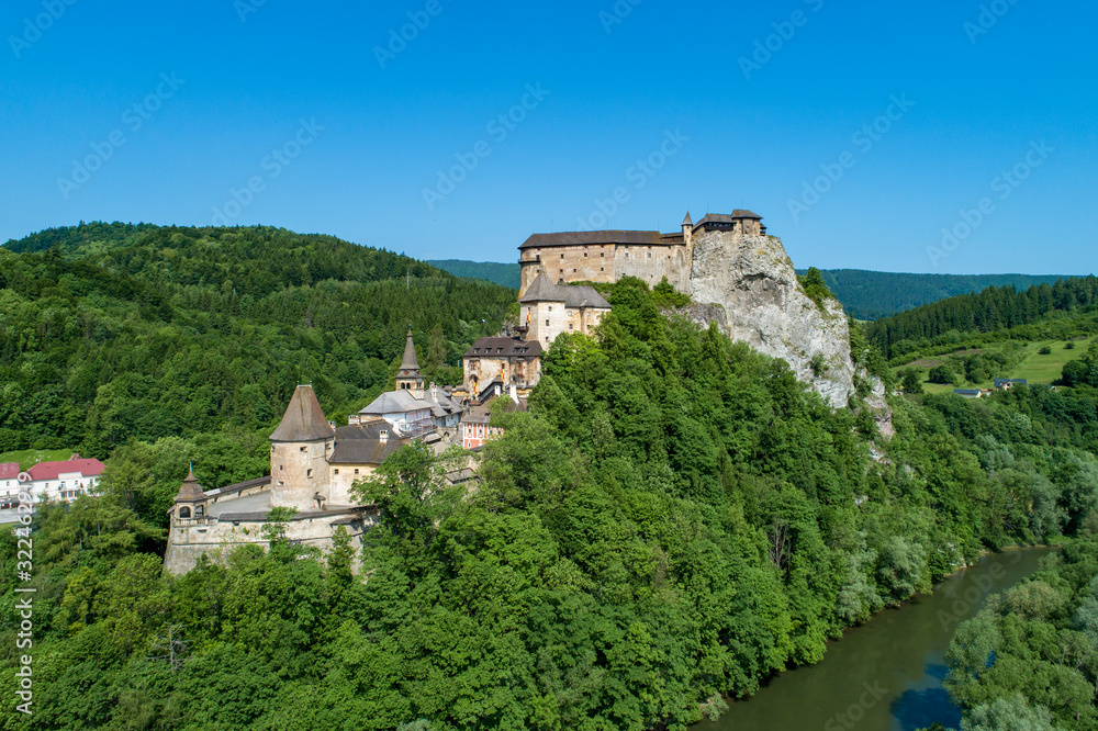 Orava castle - Oravsky Hrad in Oravsky Podzamok in Slovakia. Medieval stronghold on extremely high and steep cliff at Orava river. Aerial view