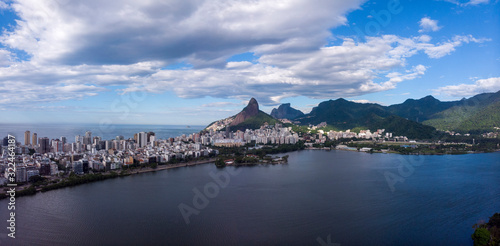 Aerial panorama of the city lake with  Two Brothers and Gavea mountain in the background against a blue sky with clouds