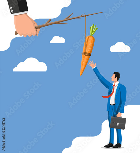 Carrot on a stick in hand and businessman. Motivation, stimulus, incentive and reaching goal concept metaphor. Fishing wooden stick with hanging carrot
