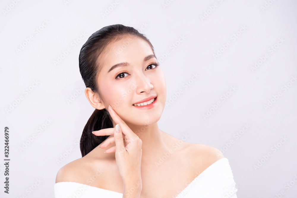 Beautiful Young Asian woman with clean fresh white skin touching own face softly in beauty pose. Girl touching with finger in isolated background. Facial treatment, cosmetology, spa, make up concept. Beautiful Young Asian woman with clean fresh white skin touching own face softly in beauty pose. Girl touching with finger in isolated background. Facial treatment, cosmetology, spa, make up concept.