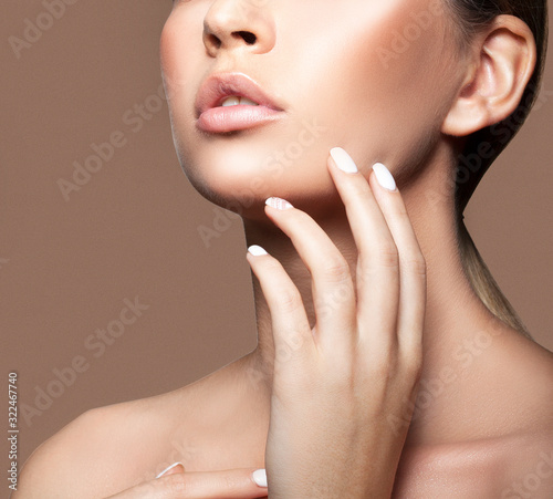 Lips of beautiful young beauty model woman, partial face with perfect skin. beige background. Skincare facial treatment concept