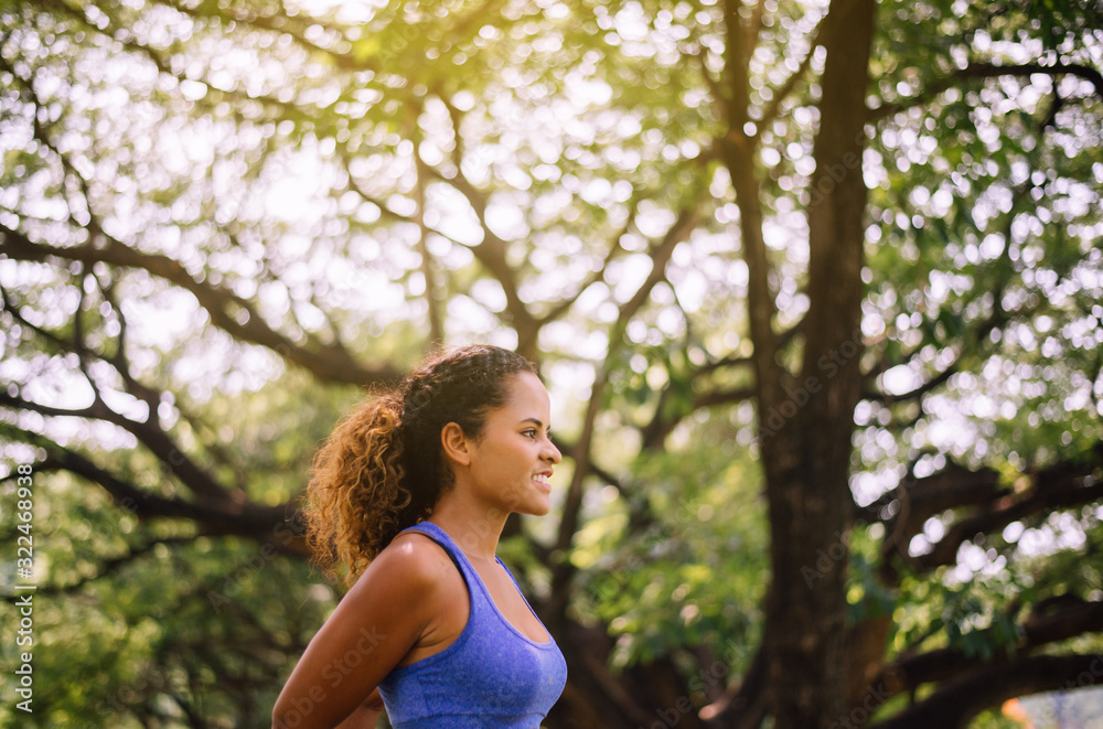 Happy black beautiful woman standing and looking something after break workout Happy black beautiful woman standing and looking something after break workout