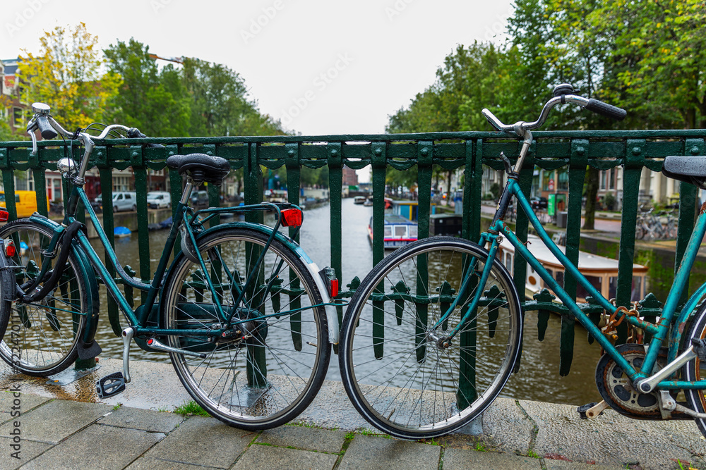 Bicycle parking on a canal in the city. Close-up.