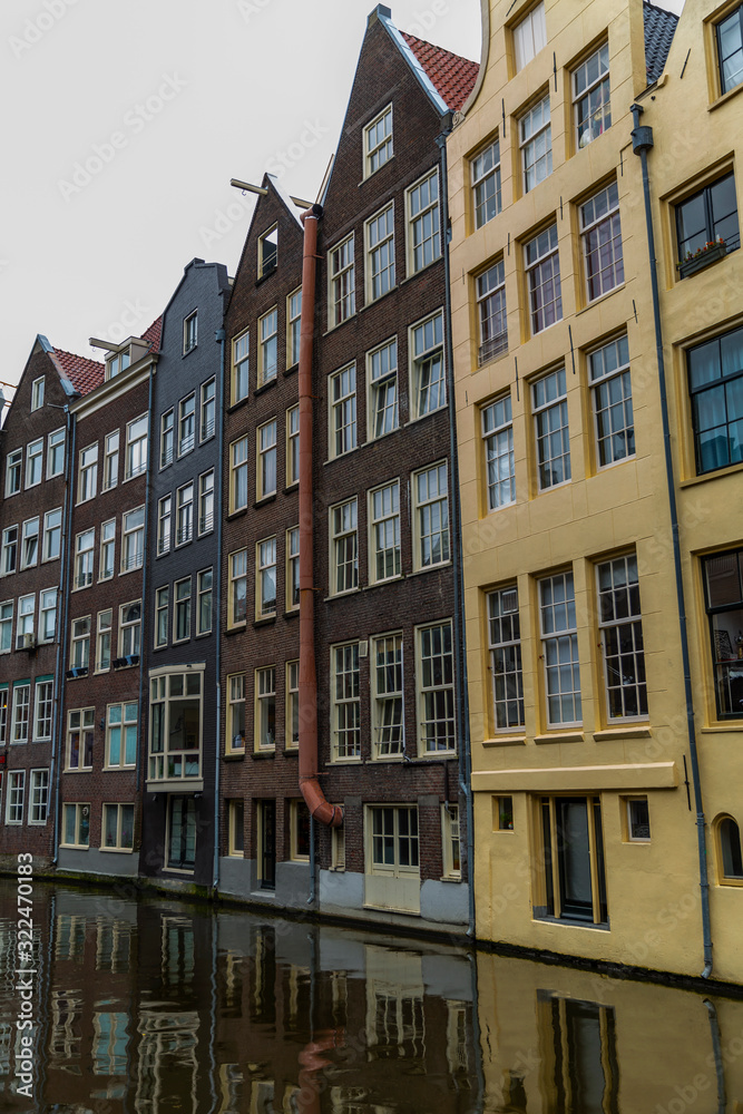 Beautiful colorful houses on a canal in Amsterdam. Vertical.