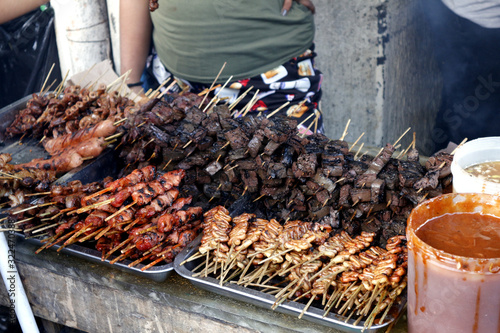 Assorted grilled pork innards such as intestine, liver, gizzard and blood in barbecue sticks photo