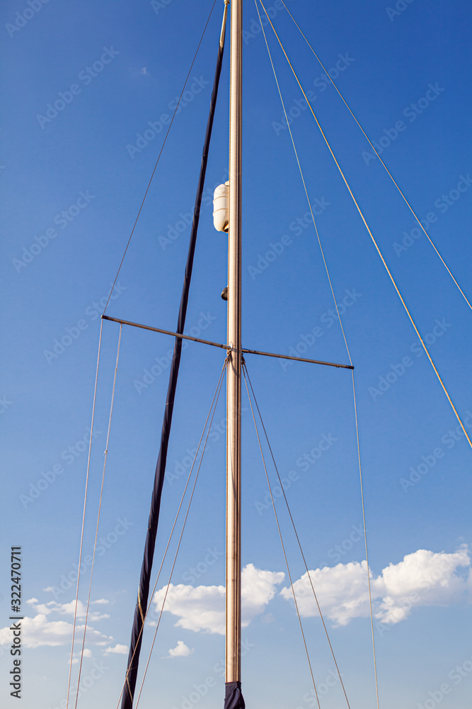 Fototapeta premium Mast of sailing yacht against blue sky background