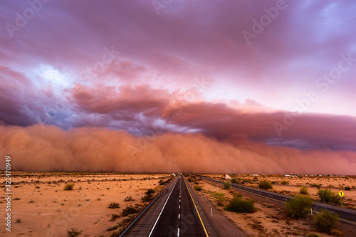 Bild auf Leinwand Dust storm in the desert over a road