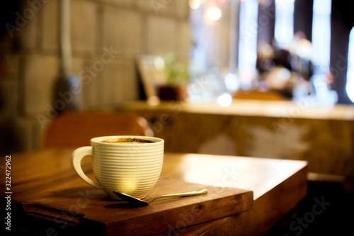 Hot coffee on wood table in cafe