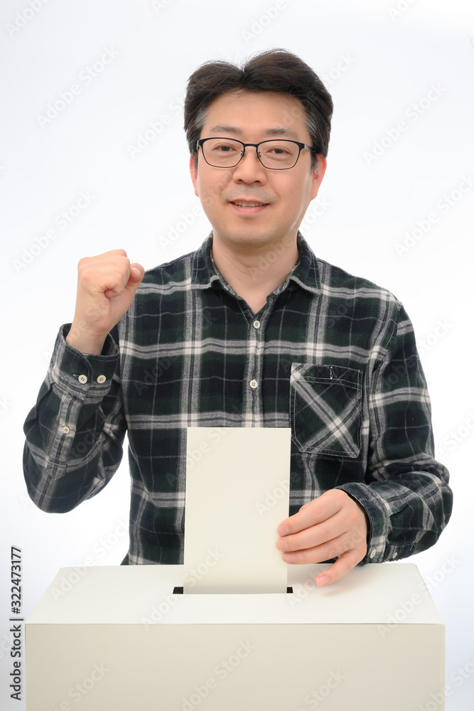 Man's hand down the ballot in the ballot box. Man's hand down the ballot in the ballot box.