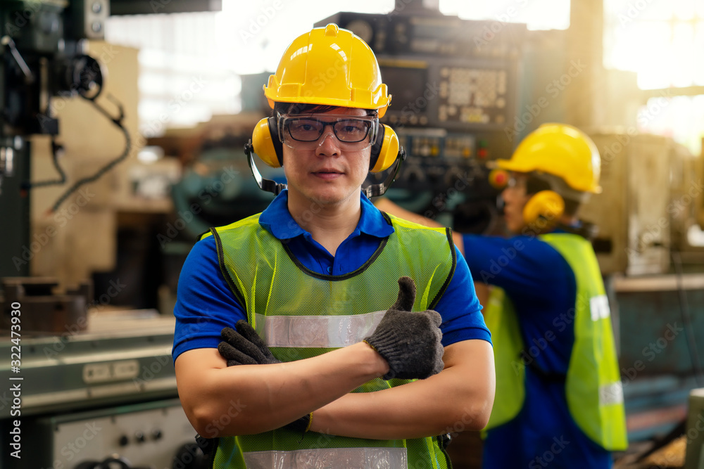 Everything is good concept. Technician or engineer in the factory showing the thumb. Well done. Asian man Industrial worker indoors in factory. Everything is good concept. Technician or engineer in the factory showing the thumb. Well done. Asian man Industrial worker indoors in factory.