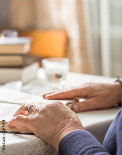 Elderly Caucasian Woman Reads A book. Pensioner Relaxation and brain education pleasure concept. Close Up. © Maria