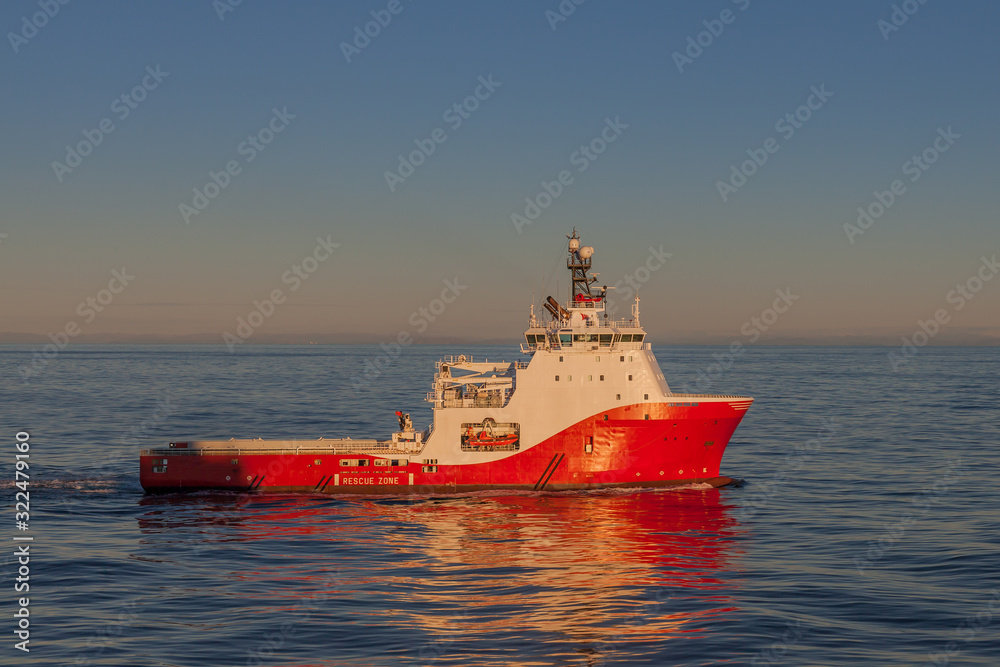 Fototapeta premium Offshore Anchor Handling vessel in the early morning in transit.