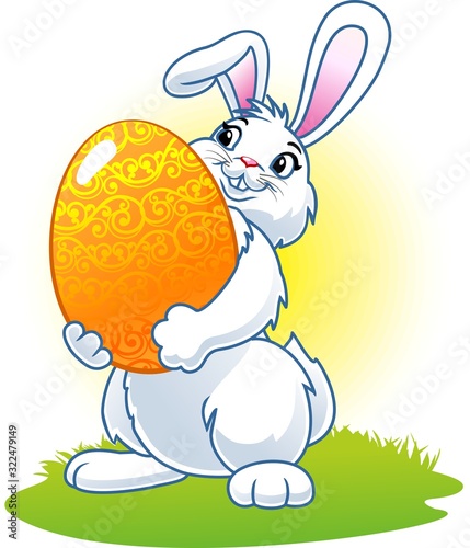 Easter bunny with a big egg in its paws. photo