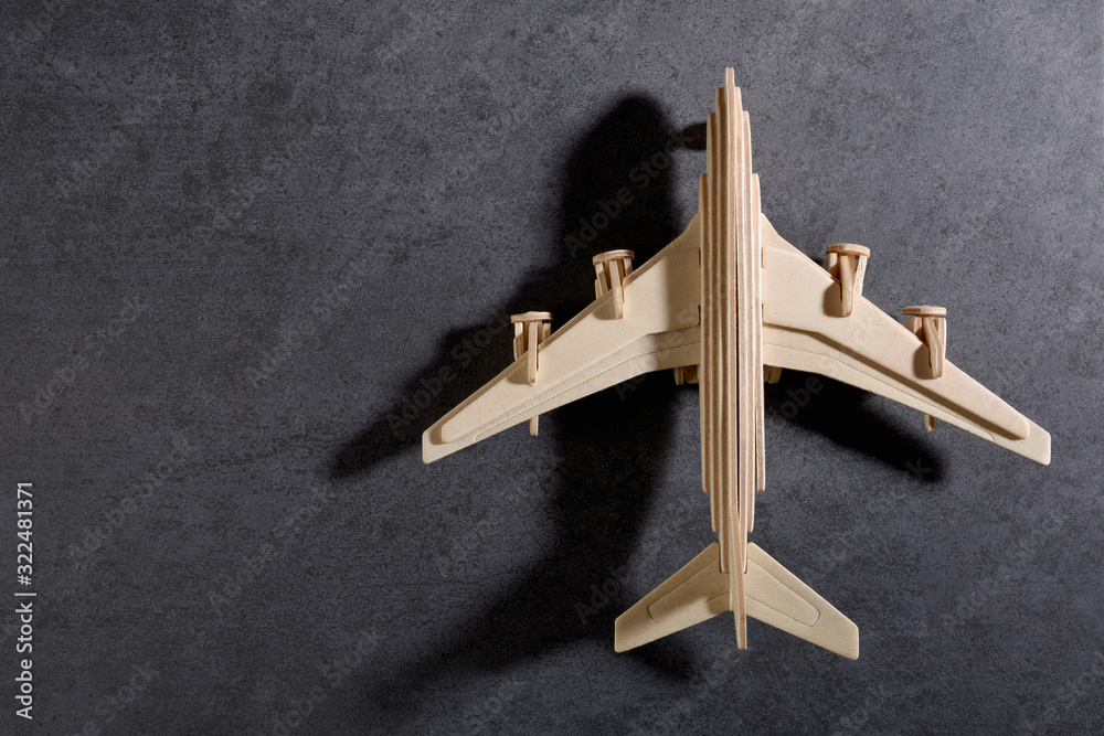 Wooden toy plane, model plane on flat stone texture Wooden toy plane, model plane on flat stone texture