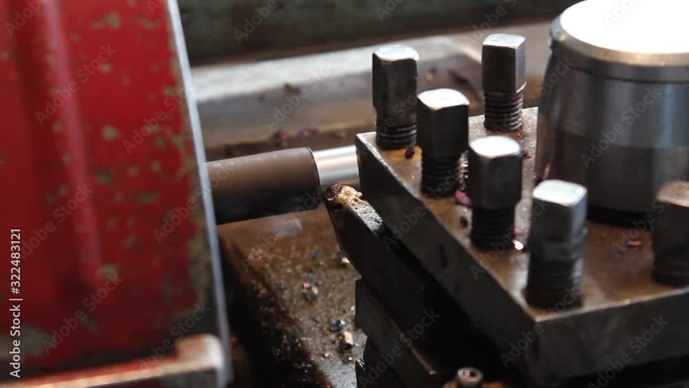 A lathe cutter processes a metal workpiece, removes chips from metal. Video shot close up. A lathe cutter processes a metal workpiece, removes chips from metal. Video shot close up.
