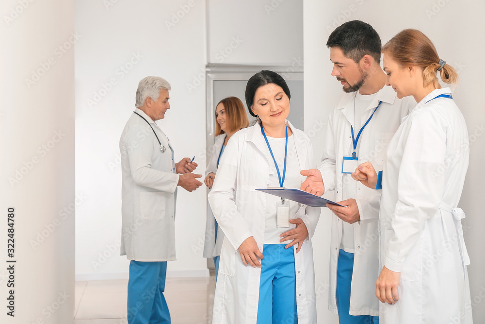 Doctors discussing something in hall of clinic Doctors discussing something in hall of clinic