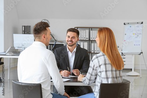 Bank manager working with clients in office photo