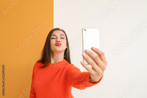 Beautiful young woman takin...