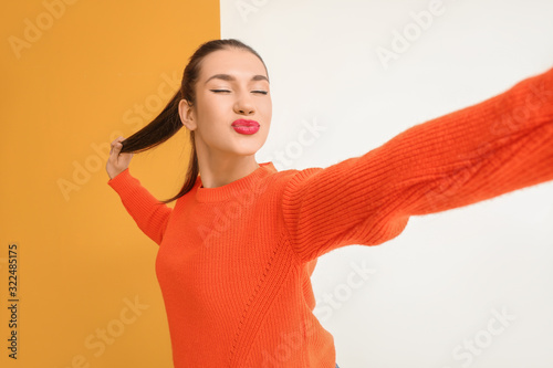 Beautiful young woman takin...