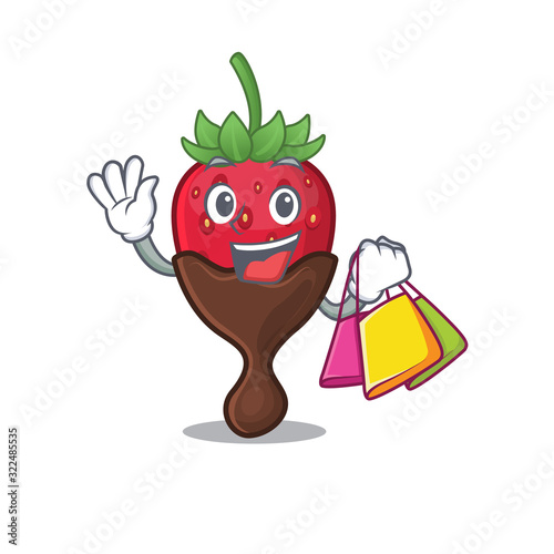 A friendly rich chocolate strawberry waving and holding Shopping bag