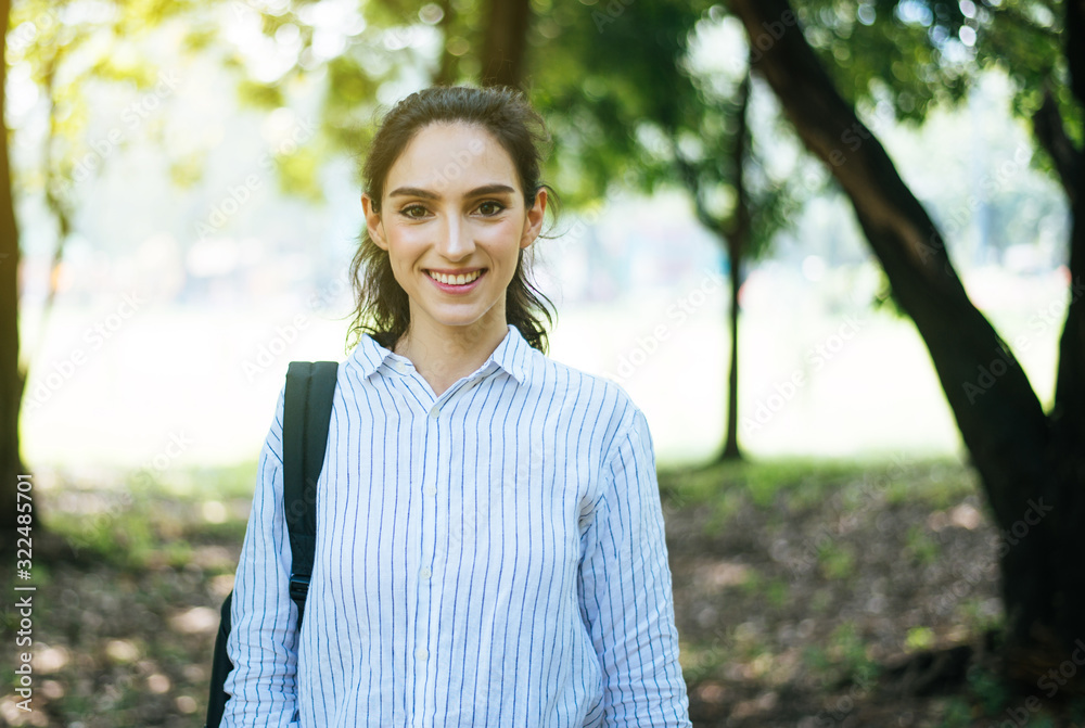 Beautiful young woman standing at public park in the morning,Happy and smiling,Relax time Beautiful young woman standing at public park in the morning,Happy and smiling,Relax time