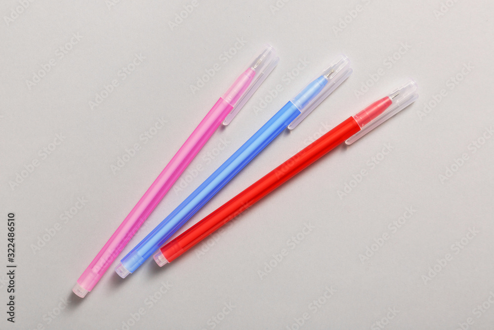 Different pens on grey background Different pens on grey background