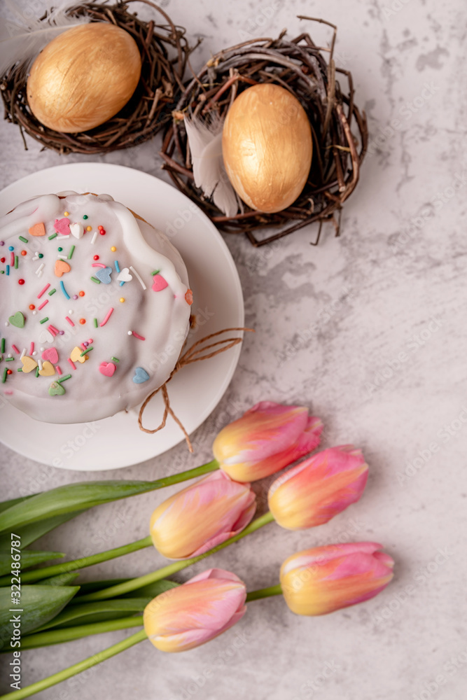 Easter cake with tulips and colored eggs top view flat lay Easter cake with tulips and colored eggs top view flat lay