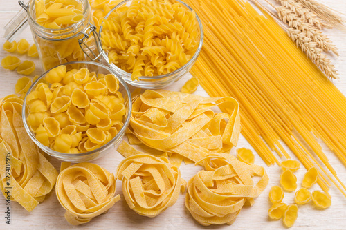 Raw pasta and spikelets of wheat