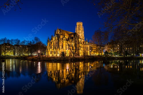 Germany  Magical stuttgart downtown skyline and reflecting ancient gothic st john church in district feuersee by night with starry sky