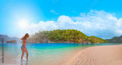 Girl on tropical beach - Beautiful woman in bikini enjoy a swim in the crystal clear water - Oludeniz Beach And Blue Lagoon, Oludeniz beach is best beaches in Turkey - Fethiye, Turkey