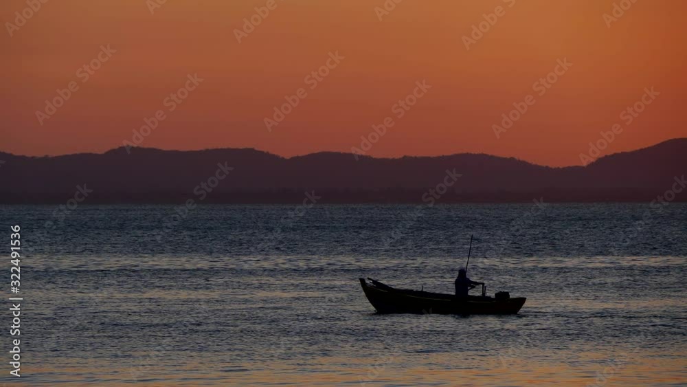 Fisherman rowing in a beautiful Seascape at dusk Fisherman rowing in a beautiful Seascape at dusk