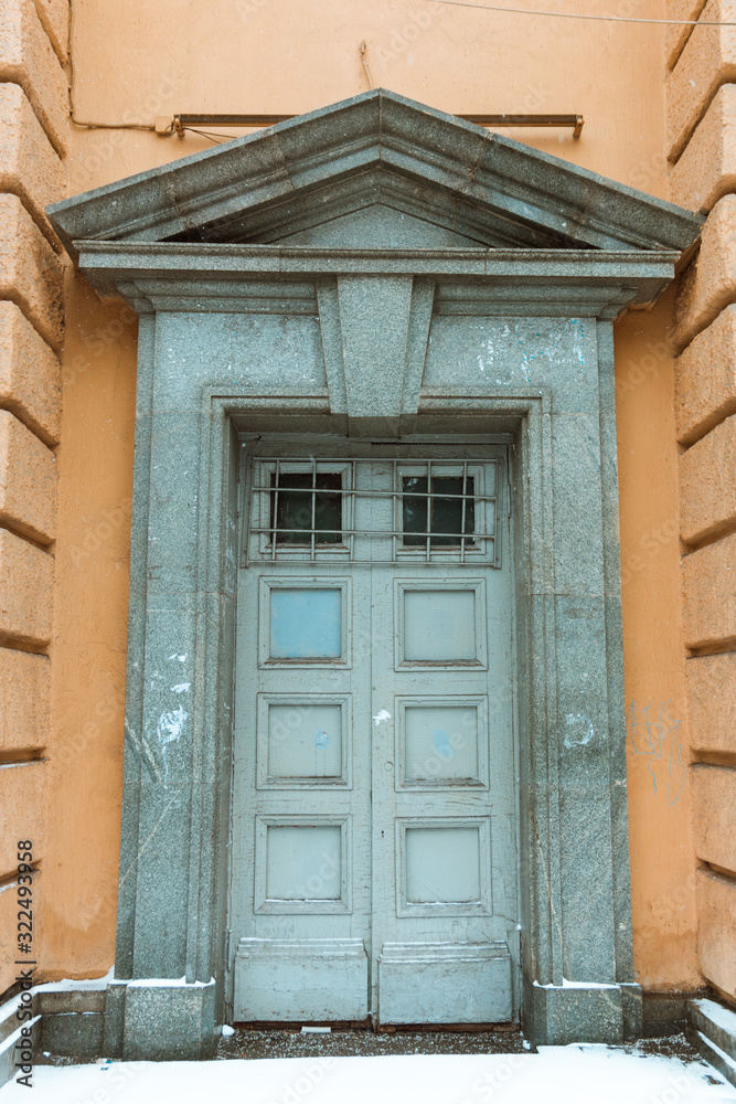 The city's postpaid grey door, the Abandoned facade of a modern building