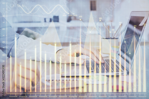 Multi exposure of stock market chart with man working on computer on background. Concept of financial analysis.