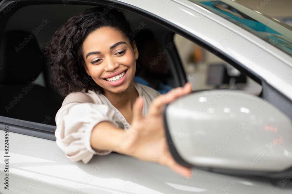 Girl Adjusting Mirrors Sitting In Car In Dealership Showroom Girl Adjusting Mirrors Sitting In Car In Dealership Showroom