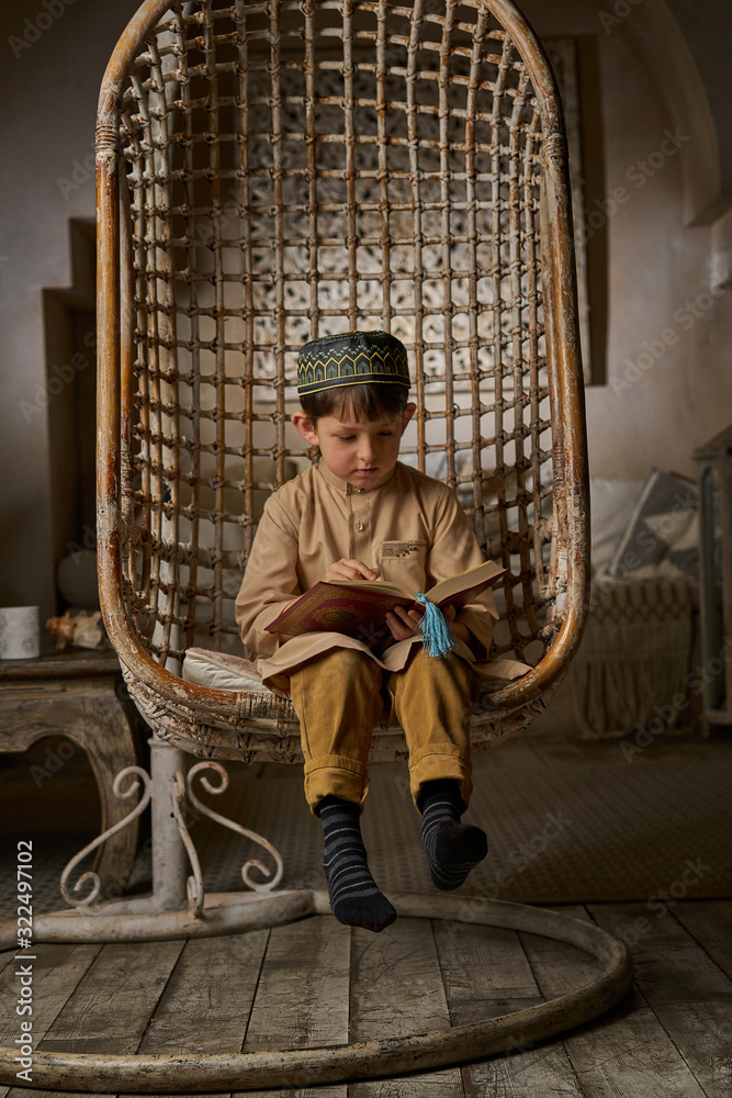 boy-in-arabic-clothes-with-rosary-beads-reading-holy-quran-book-praying