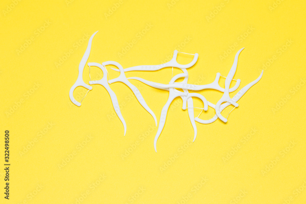 Plastic toothpick on a yellow isolated background. Hygiene and dental care. Plastic toothpick on a yellow isolated background. Hygiene and dental care.