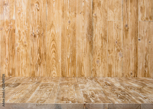 Old wood table with blurred concrete wall in room background