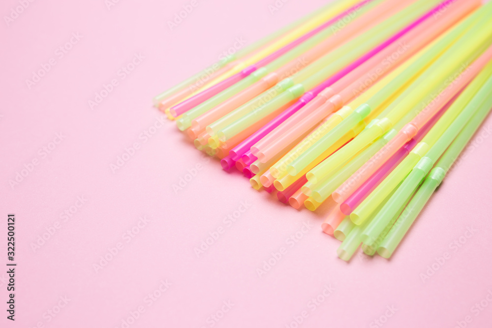 Colored cocktail straws close-up on a pink isolated background. Colored cocktail straws close-up on a pink isolated background.