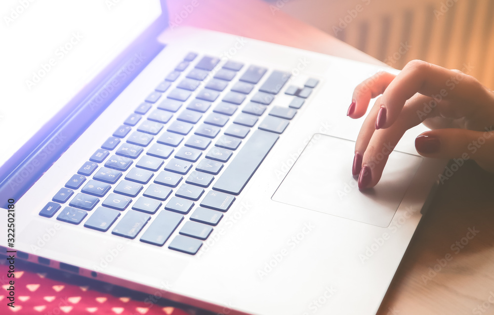 Woman's hands on the laptop. Beautiful flowers and linen tablecloth. Perfect working place at home. Freelance concept. Searching on the internet. Woman's hands on the laptop. Beautiful flowers and linen tablecloth. Perfect working place at home. Freelance concept. Searching on the internet.