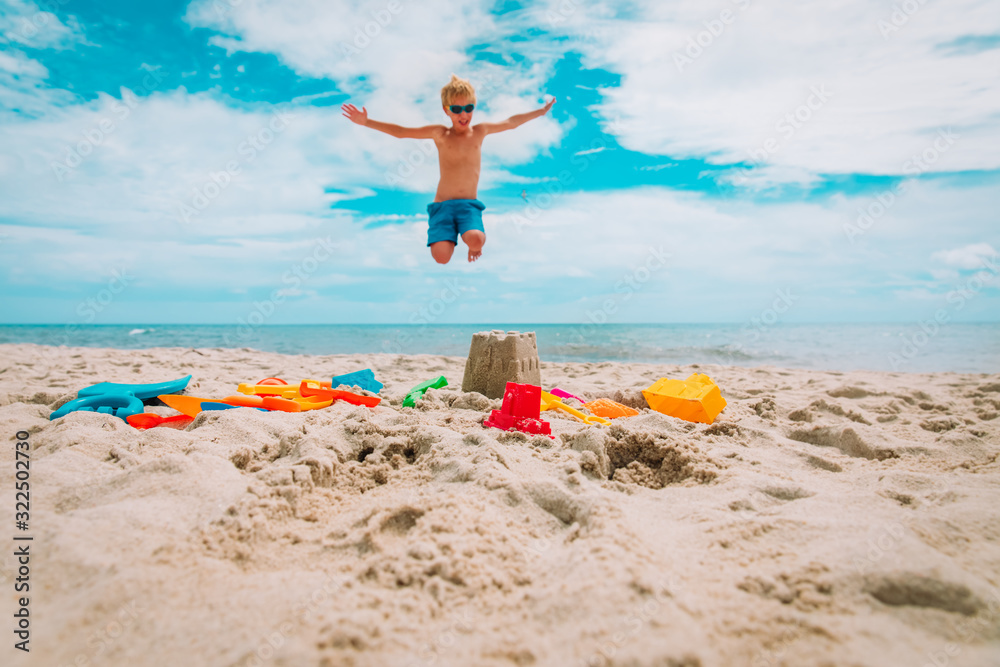 toys on sand beach and happy boy enjoy tropical vacation toys on sand beach and happy boy enjoy tropical vacation
