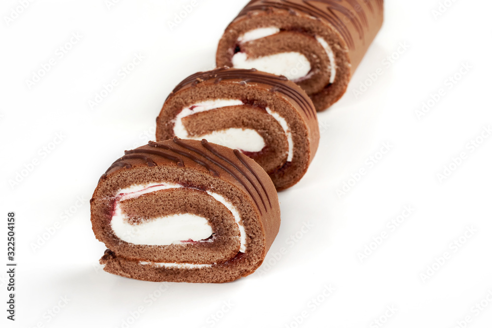 Sliced chocolate biscuit roll cake isolated on white background. Sliced chocolate biscuit roll cake isolated on white background.