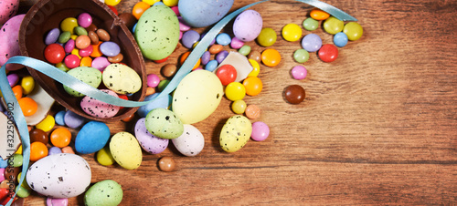 Colorful Easter candies on a rustic wood background