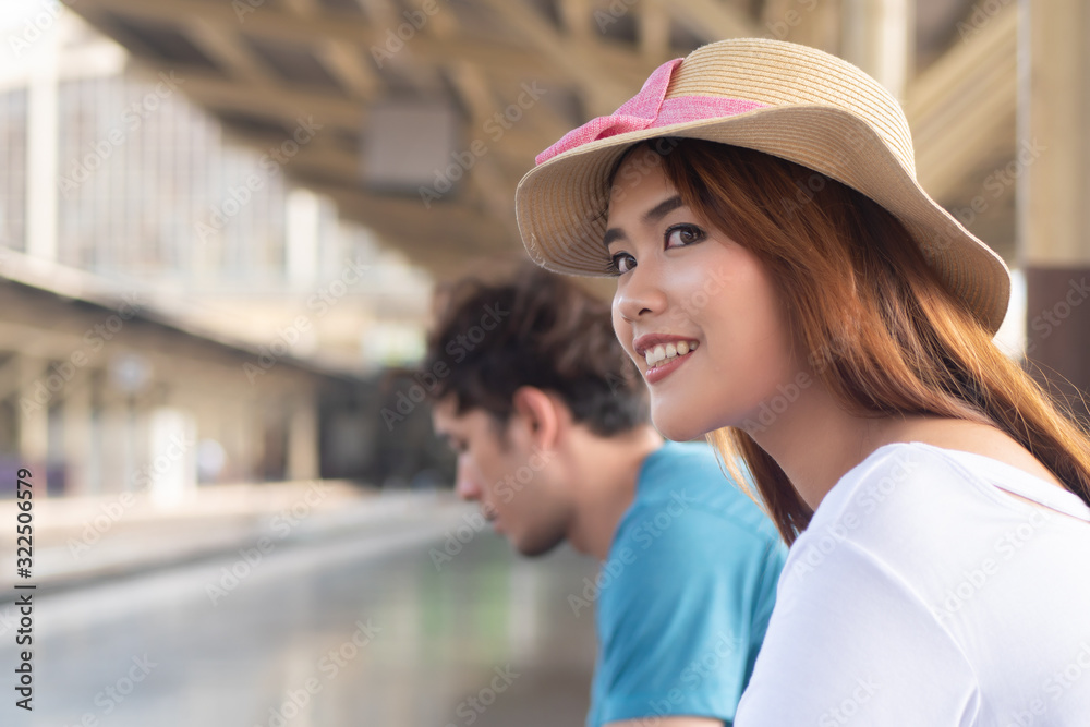 woman traveler waiting for train; new adventure, summer vacation, public transportation, budget travel, comfortable travel, girl traveler on long vacation, stress management, outdoor activity concept